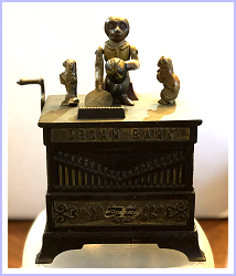 Image of organ grinder with cat and dog casst iron mechanical bank